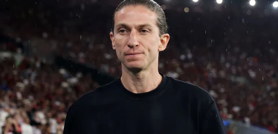 Coach on the sideline during a rainy match
