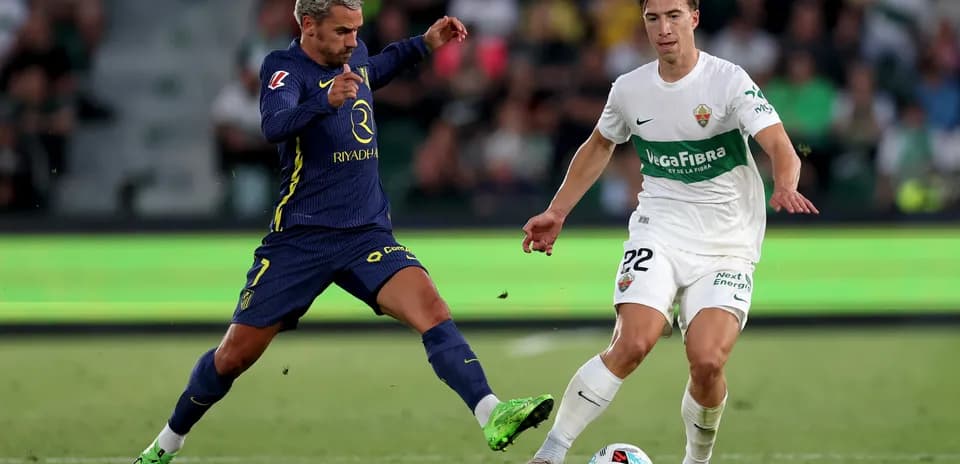 Player challenges for the ball during Elche match
