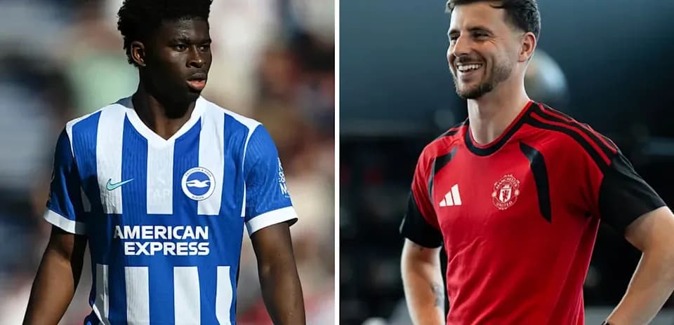 Two football players in team kits posing for photo
