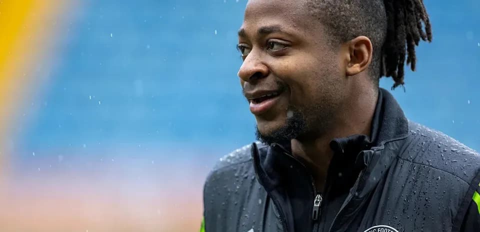 Player wearing Celtic Football Club jacket outdoors