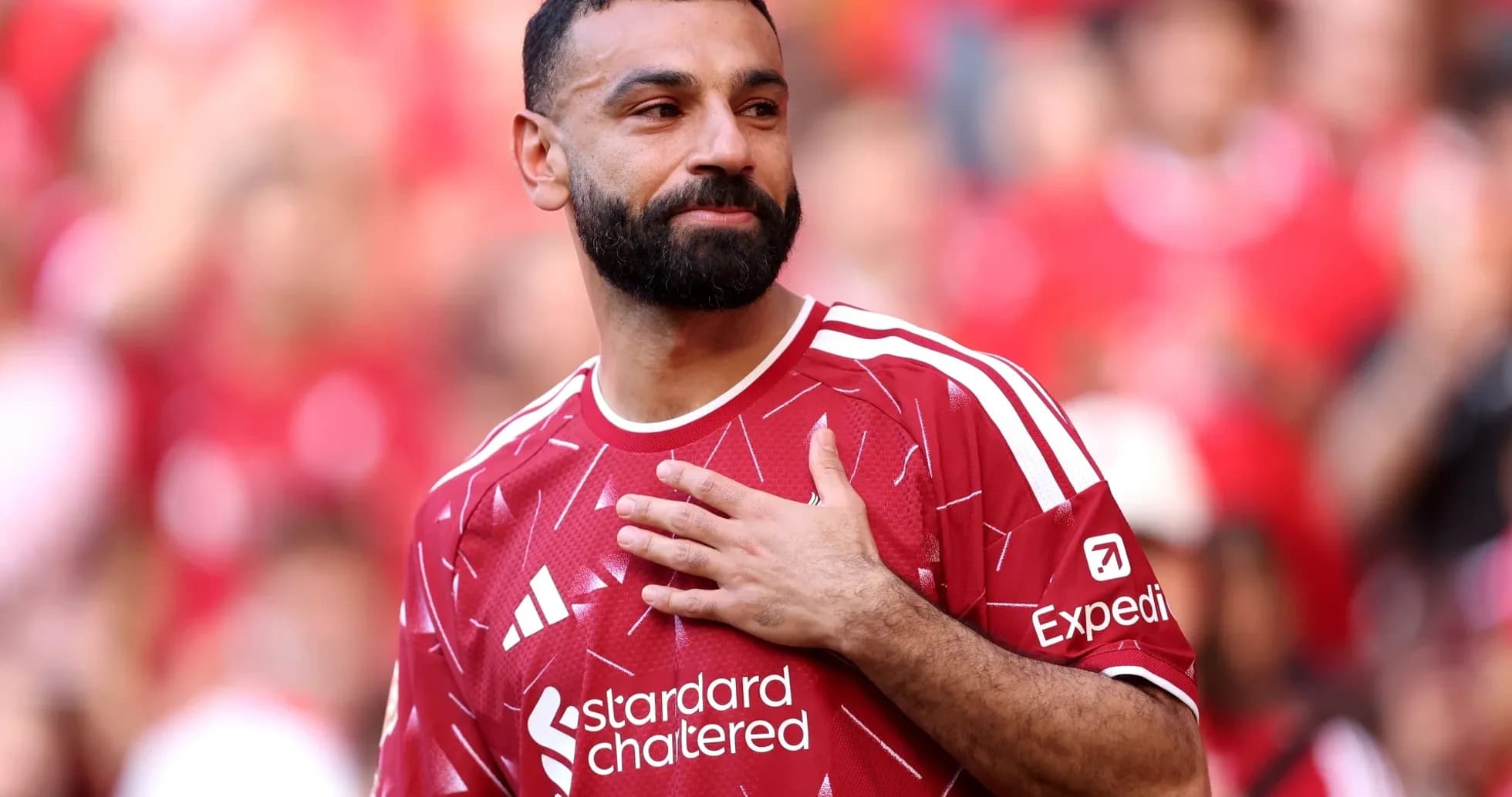 Player in red jersey gestures during presentation