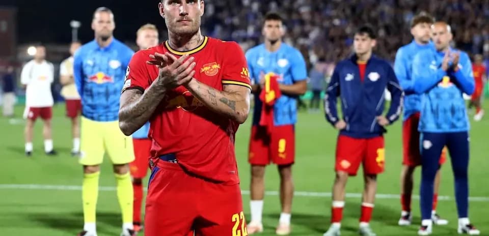 Player applauding with teammates in background