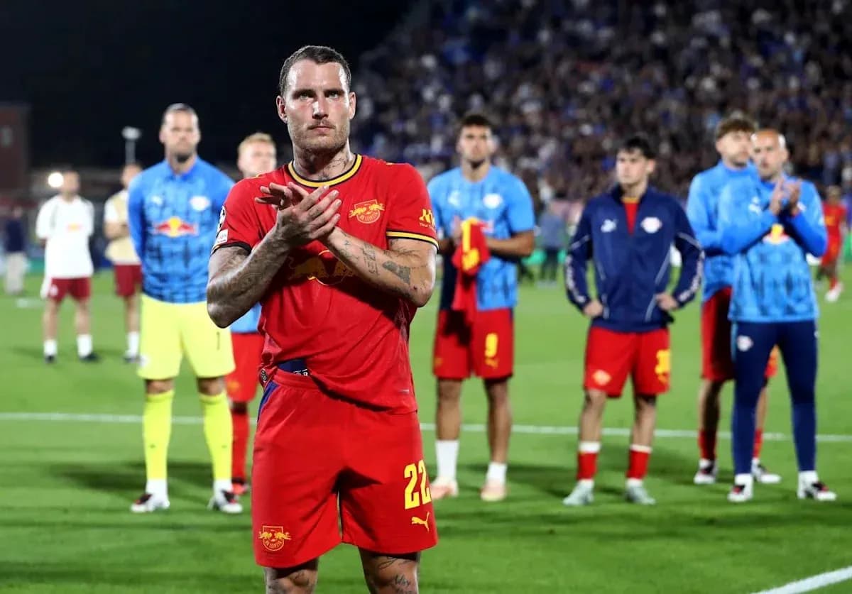 Player applauding with teammates in background