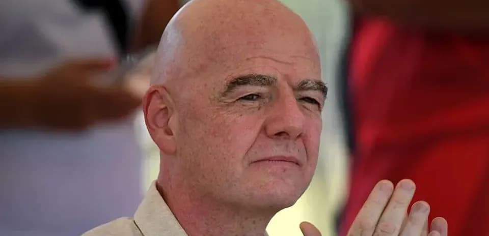 Man with bald head sitting and clapping hands