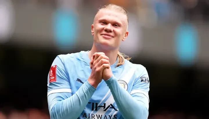 Player celebrating on the pitch in Manchester City jersey
