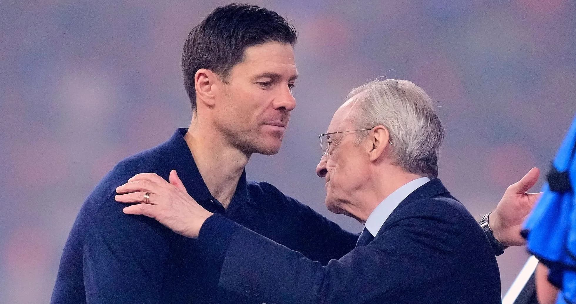 Two men embracing during a formal event