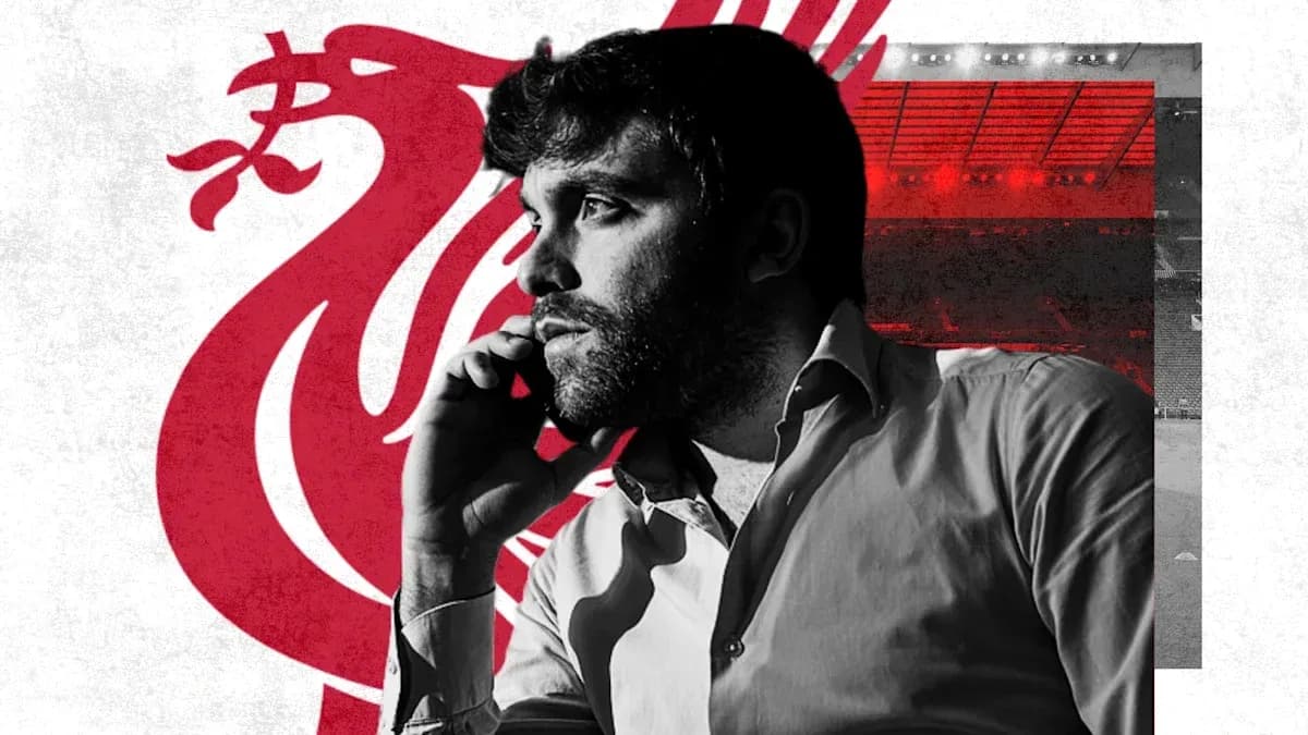 Person on phone with Liverpool logo in background