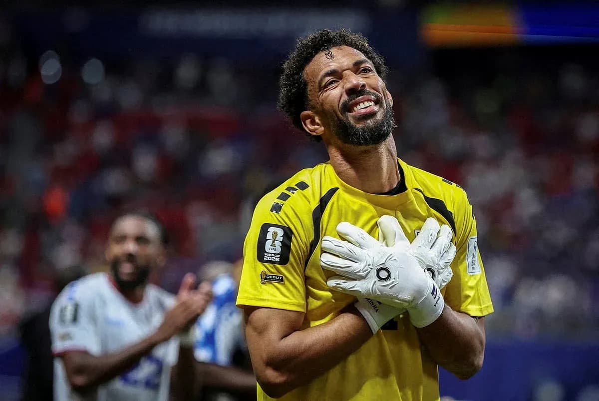 Goalkeeper celebrating with gloves raised after match