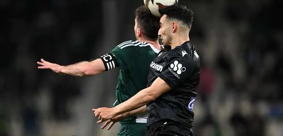 Players contesting a header during PAOK vs Panathinaikos
