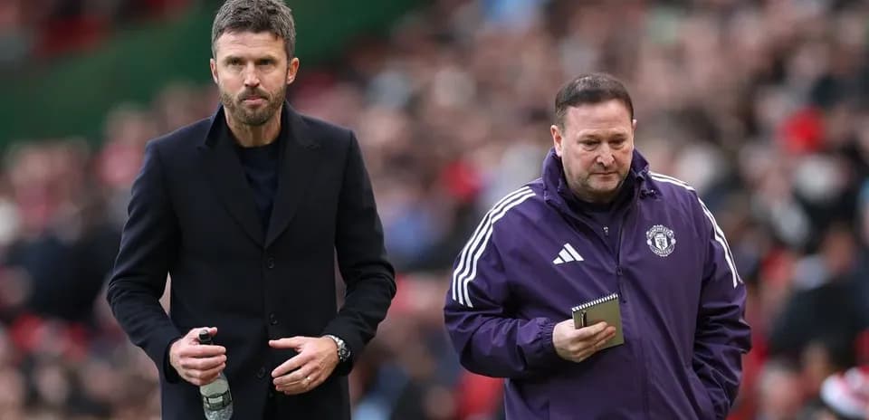 Two coaches walking on the sideline during match