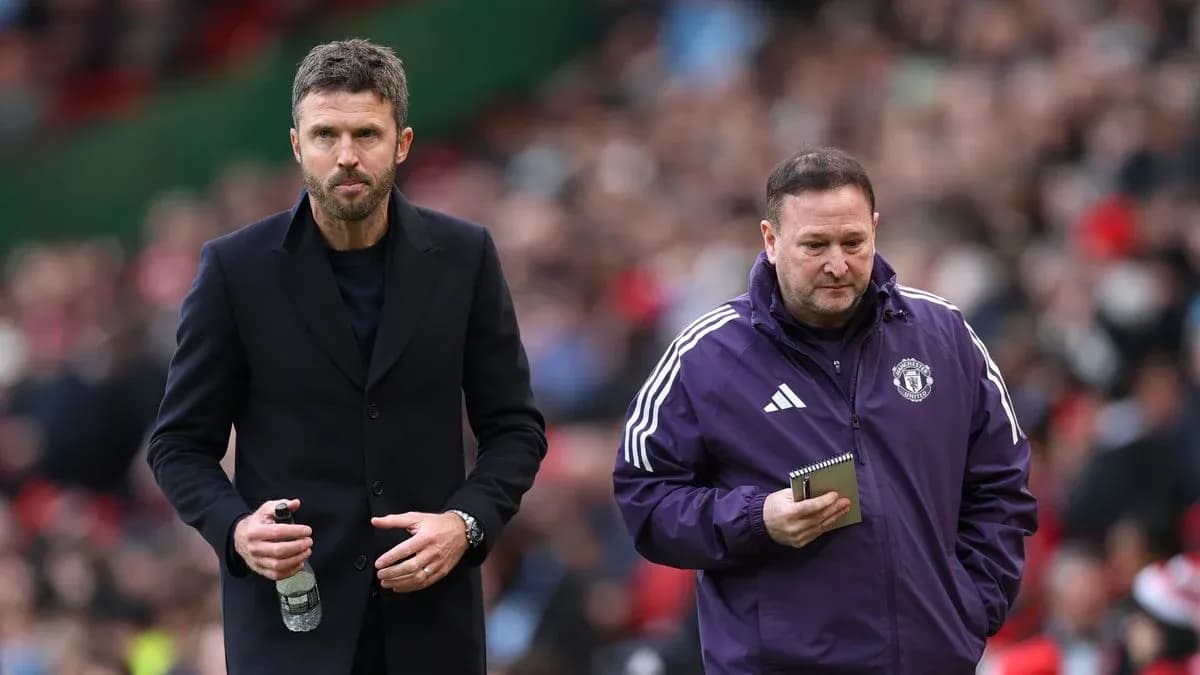 Two coaches walking on the sideline during match