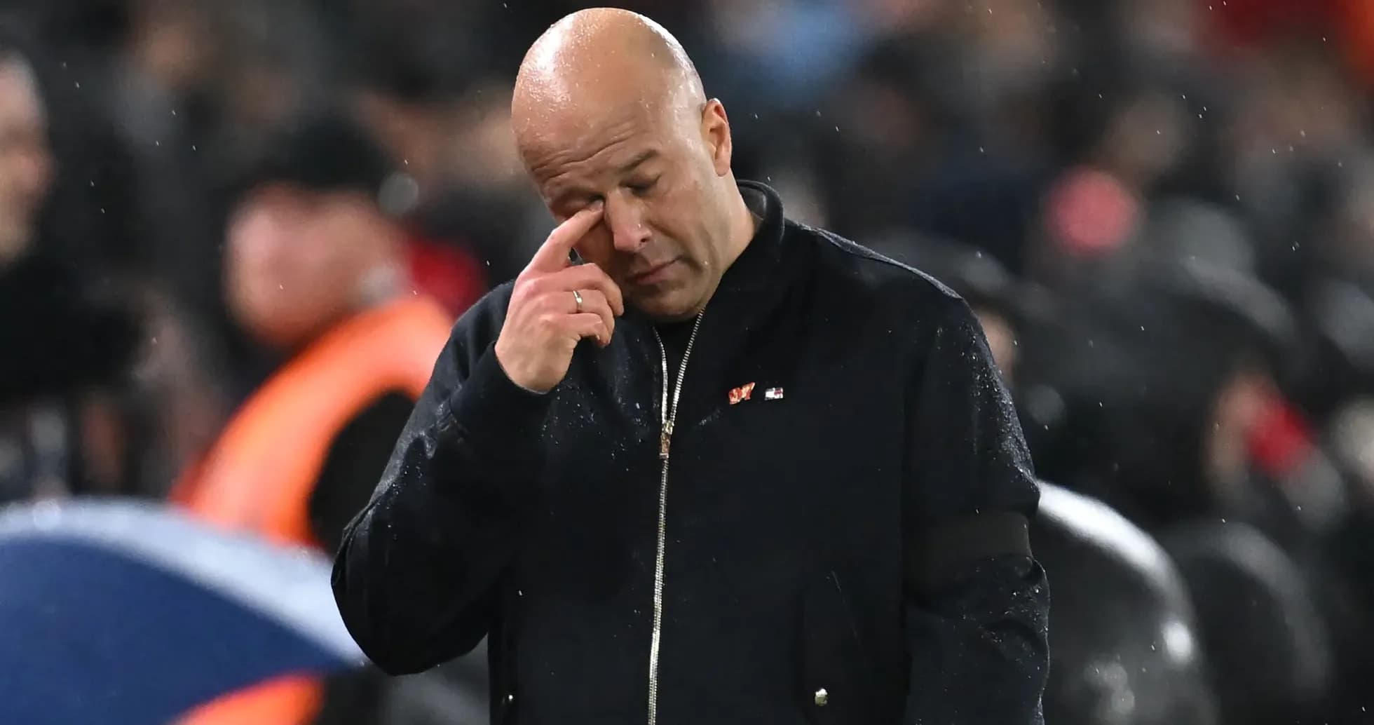 Coach wiping his brow during a match