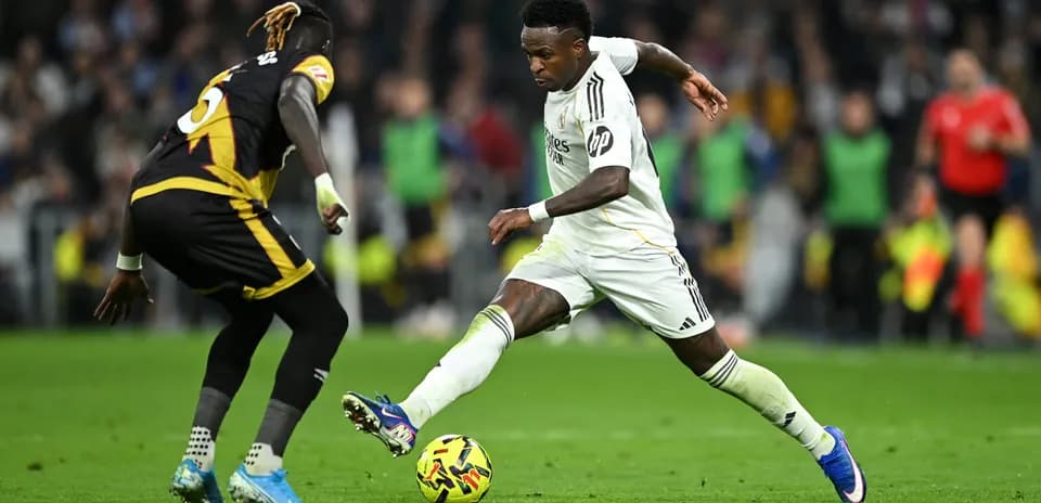 Vinicius Jr. dribbling past defender during match