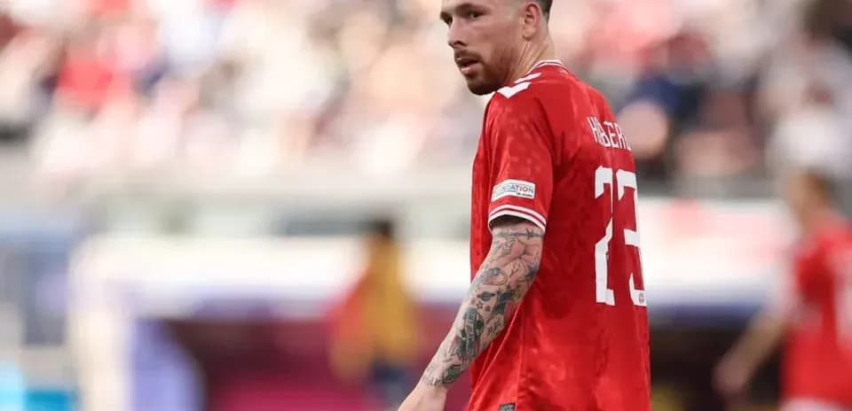 Player in red jersey during match on field