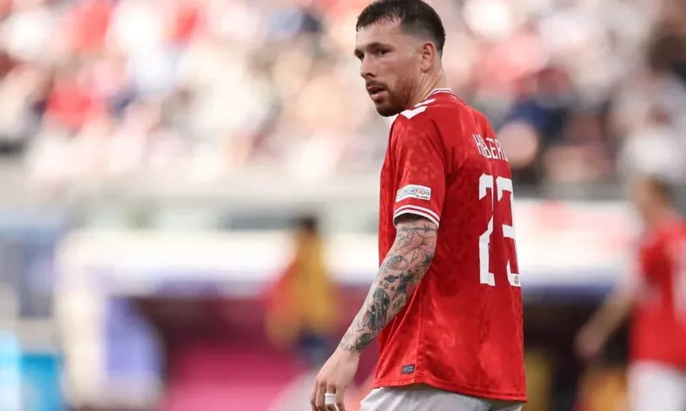 Player in red jersey during match on field