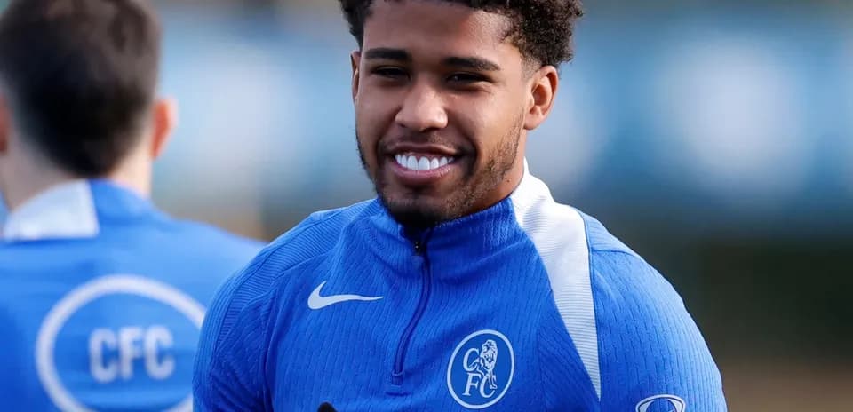 Player smiling during training session in blue kit