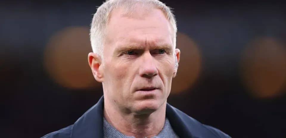Man with short hair looking intently at camera