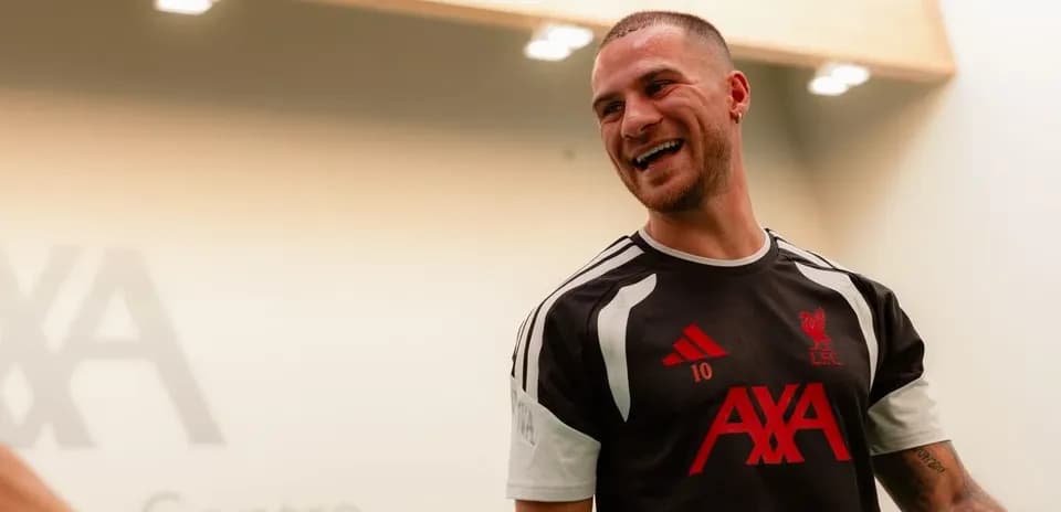 Player smiling in Liverpool training kit at AXA Centre