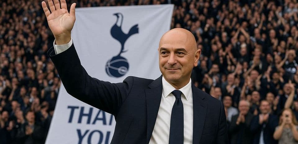 Man waving in front of cheering crowd and banner