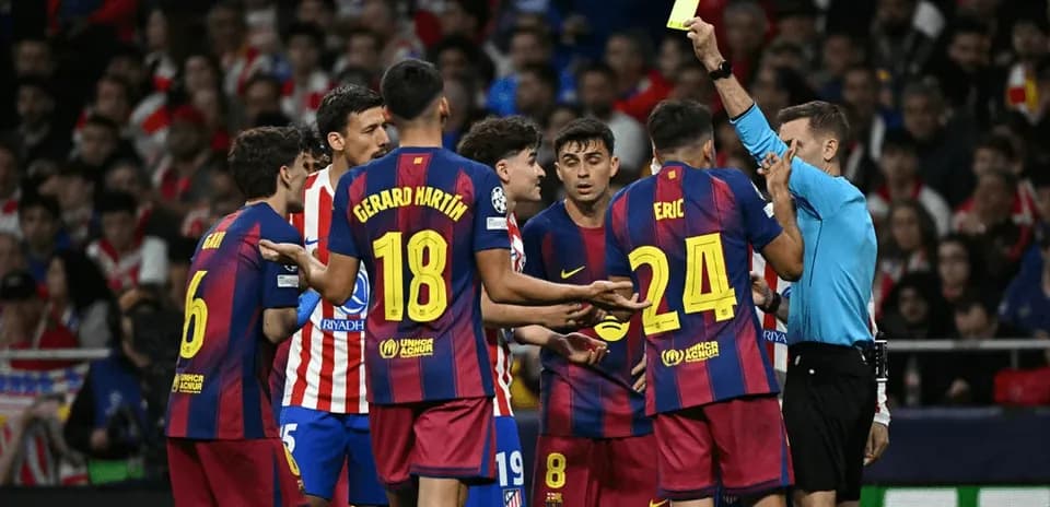 Referee showing yellow card to Barcelona players