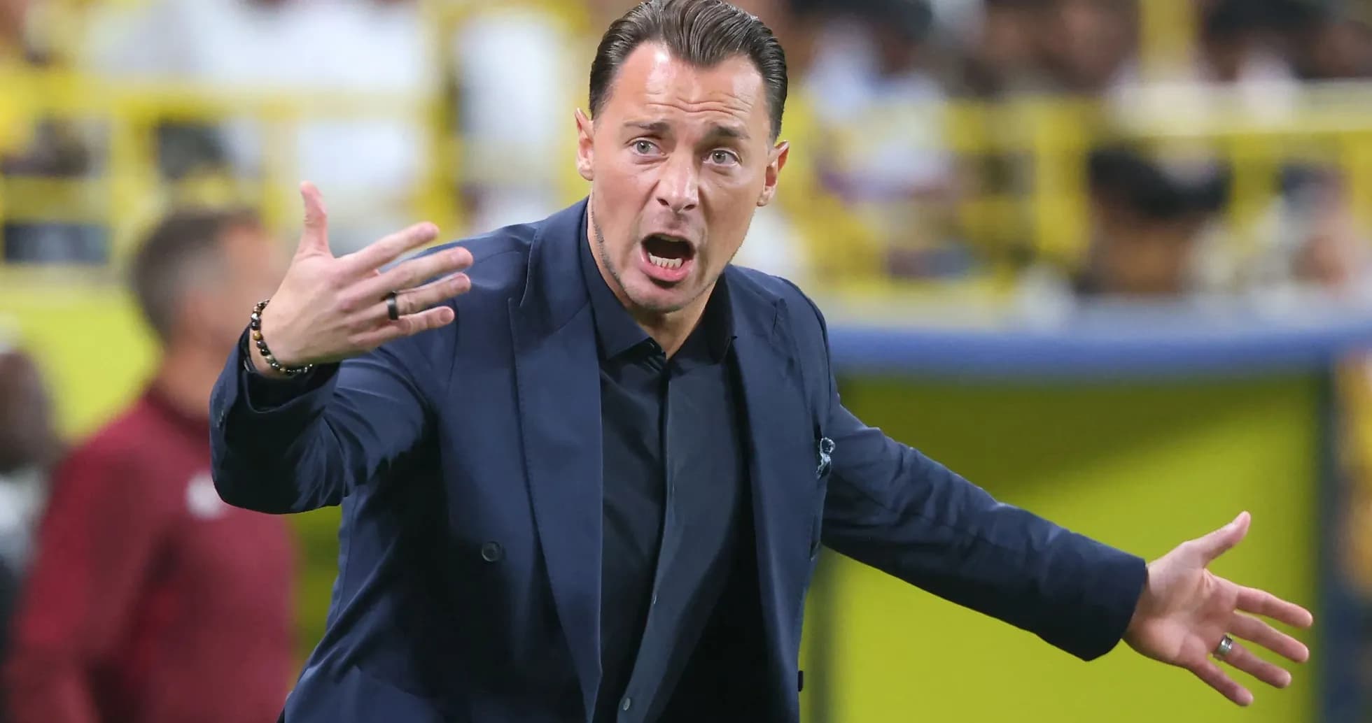 Coach gesturing passionately during a match