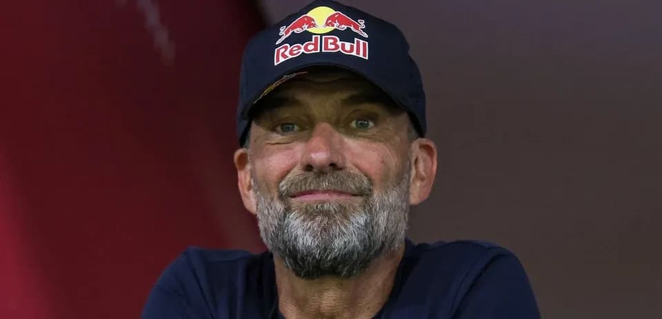 Coach wearing Red Bull cap during event