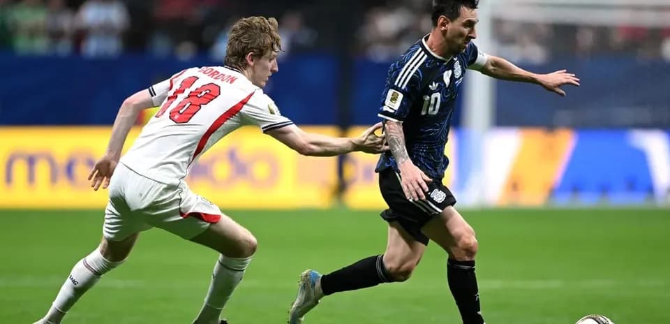 Player wearing blue jersey evading opponent in match