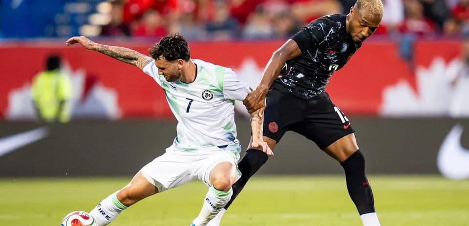 Two players competing for the ball on field
