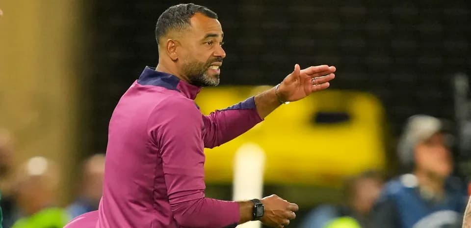Coach giving instructions on the sidelines during match