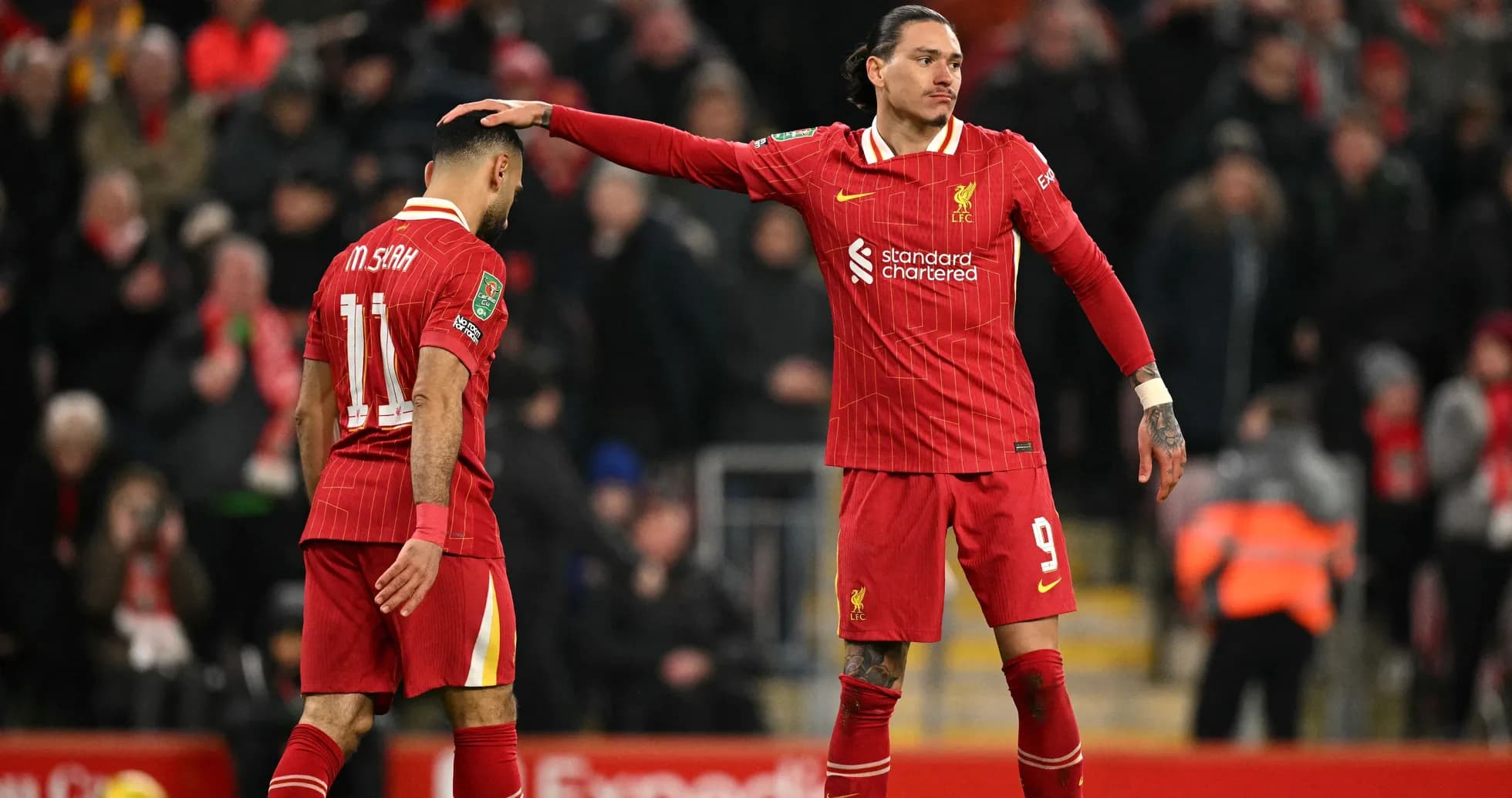 Two Liverpool players on the pitch during match