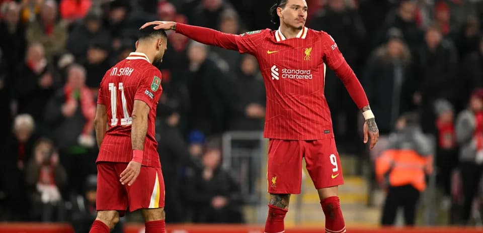 Two Liverpool players on the pitch during match