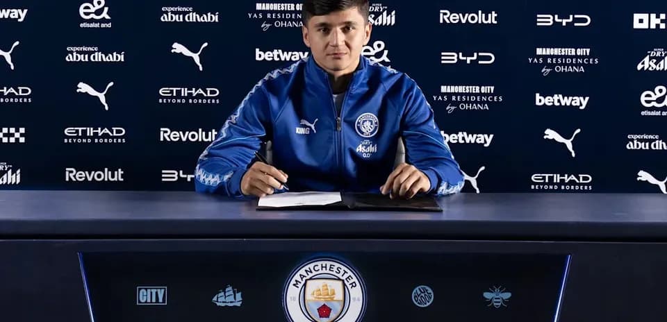 Player signing contract at Manchester City press conference