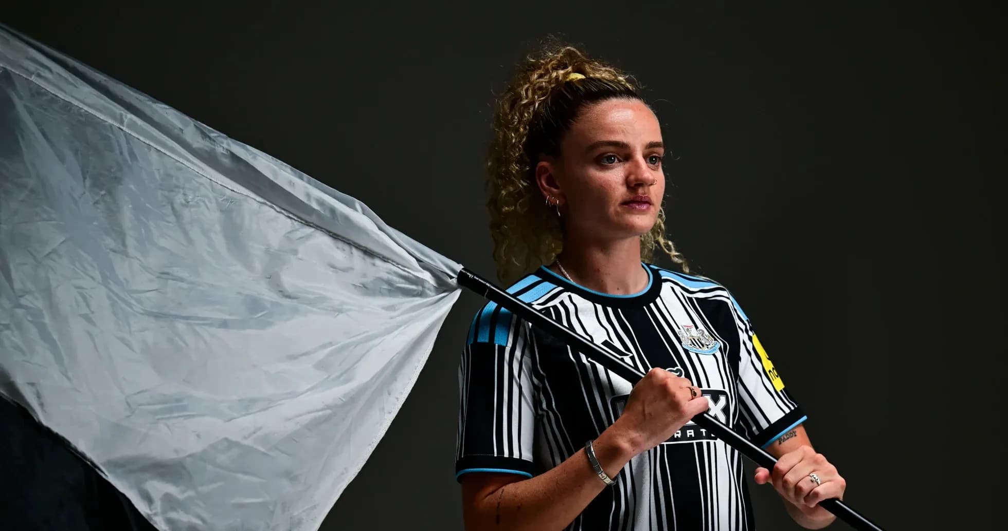 Player holding a flag in Newcastle kit