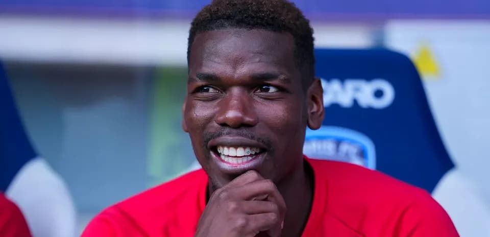 Player sitting on bench during match, smiling