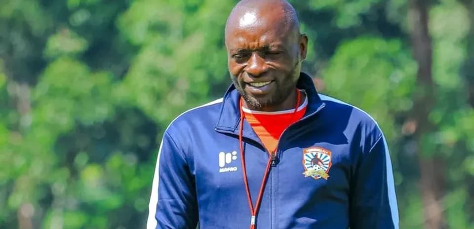 Coach walking on training pitch during session