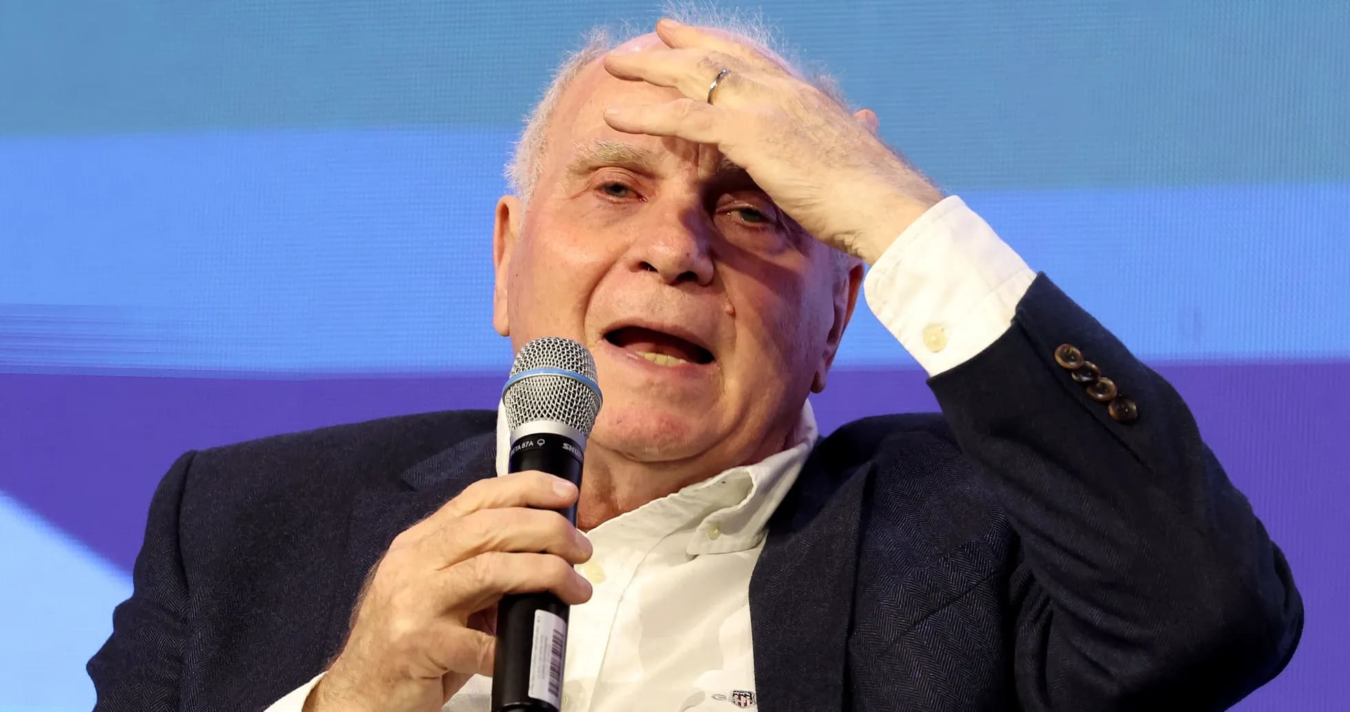 Speaker holding microphone during discussion on stage