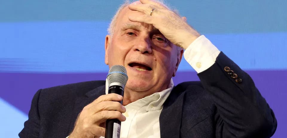 Speaker holding microphone during discussion on stage