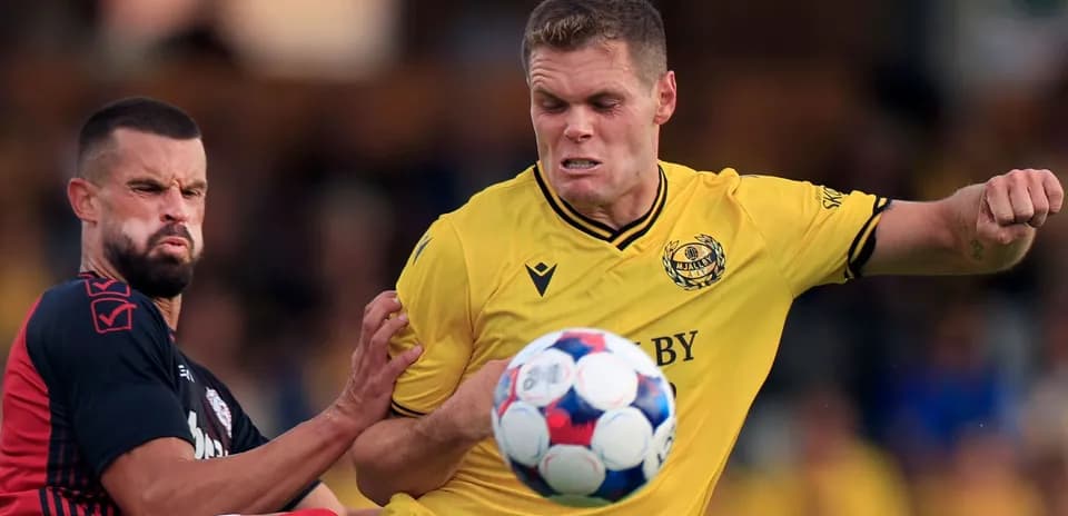 Mjallby player challenges Slovan Bratislava opponent