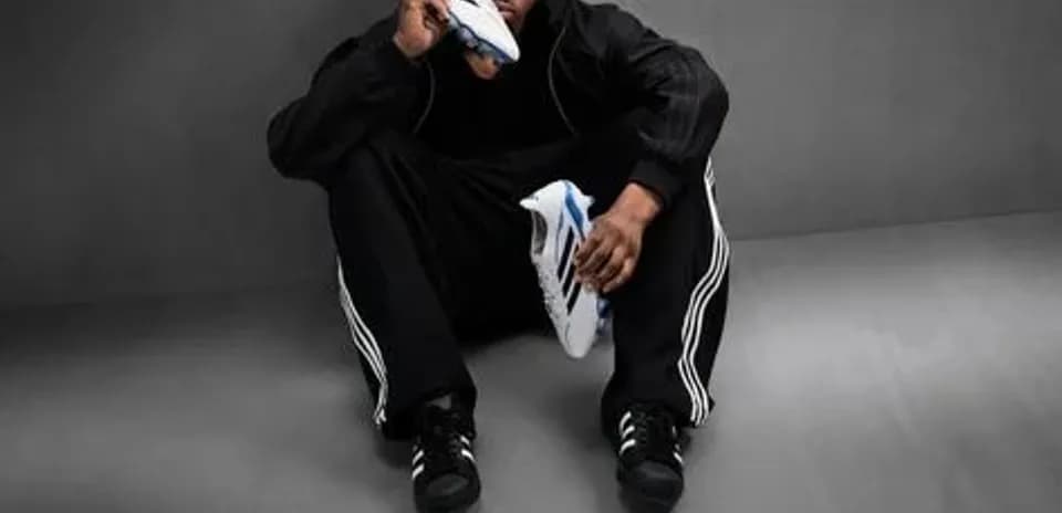 Athlete sitting with soccer shoes in studio setting