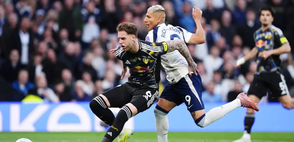 Leeds player challenged by Tottenham player