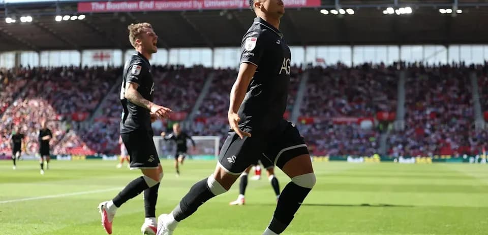 Swansea City players celebrating a goal during match