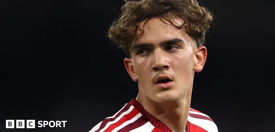 Football player wearing red jersey during match
