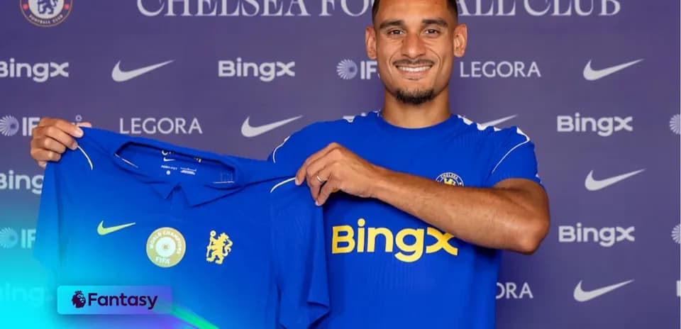 Player holding Chelsea jersey during announcement event