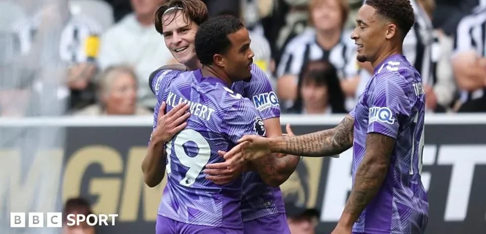 Players celebrating a goal on the field