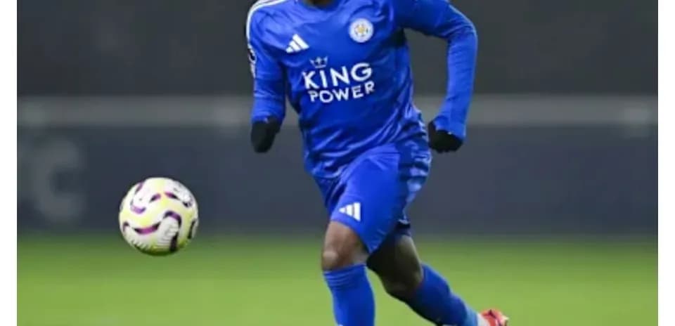 Player in blue kit dribbling a soccer ball