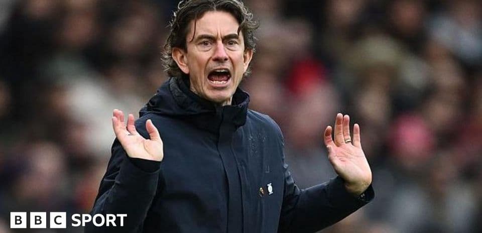 Manager gesturing during a match on the sideline