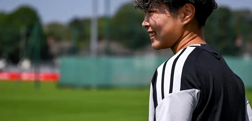 Player walking on training pitch in sunny weather