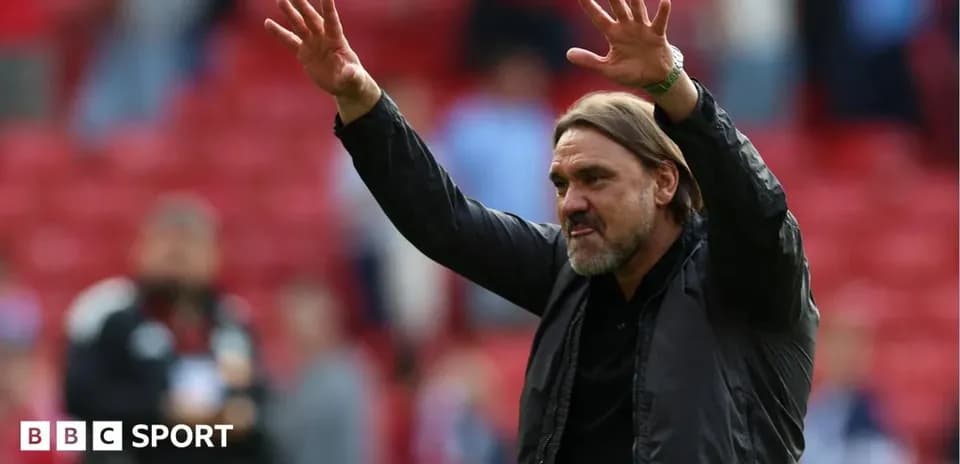 Coach gesturing to crowd during match celebration