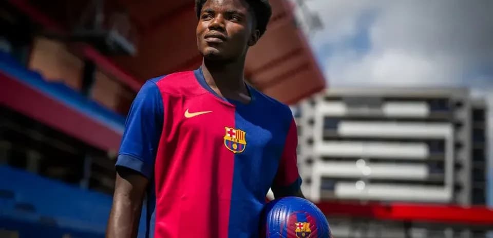 Player holding a football in Barcelona kit