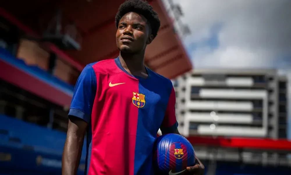 Player holding a football in Barcelona kit